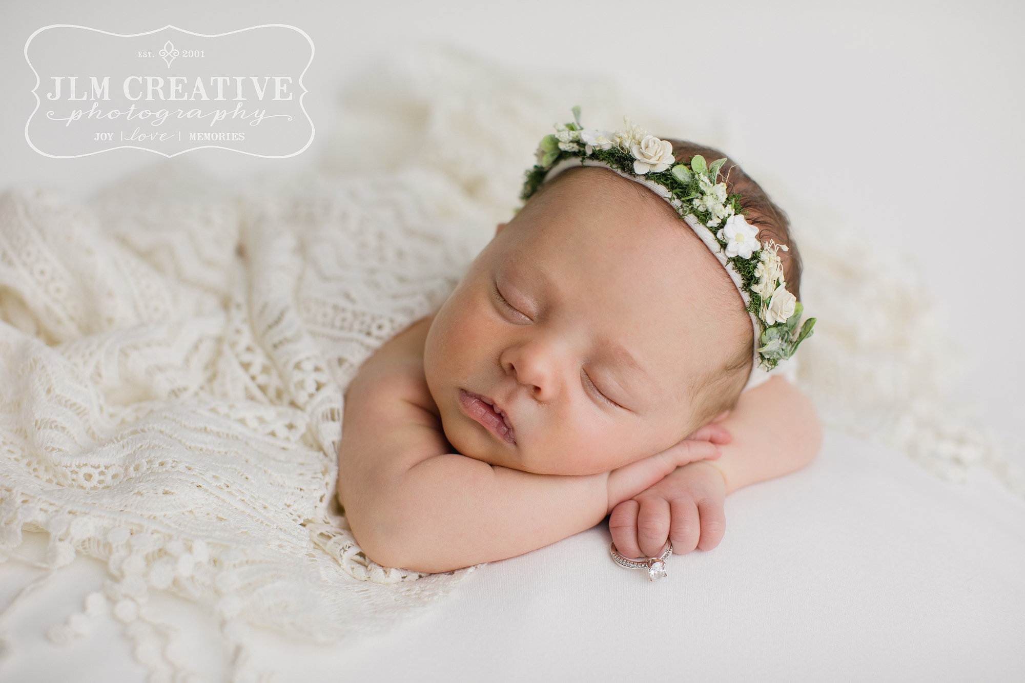 new baby girl with white flower crown