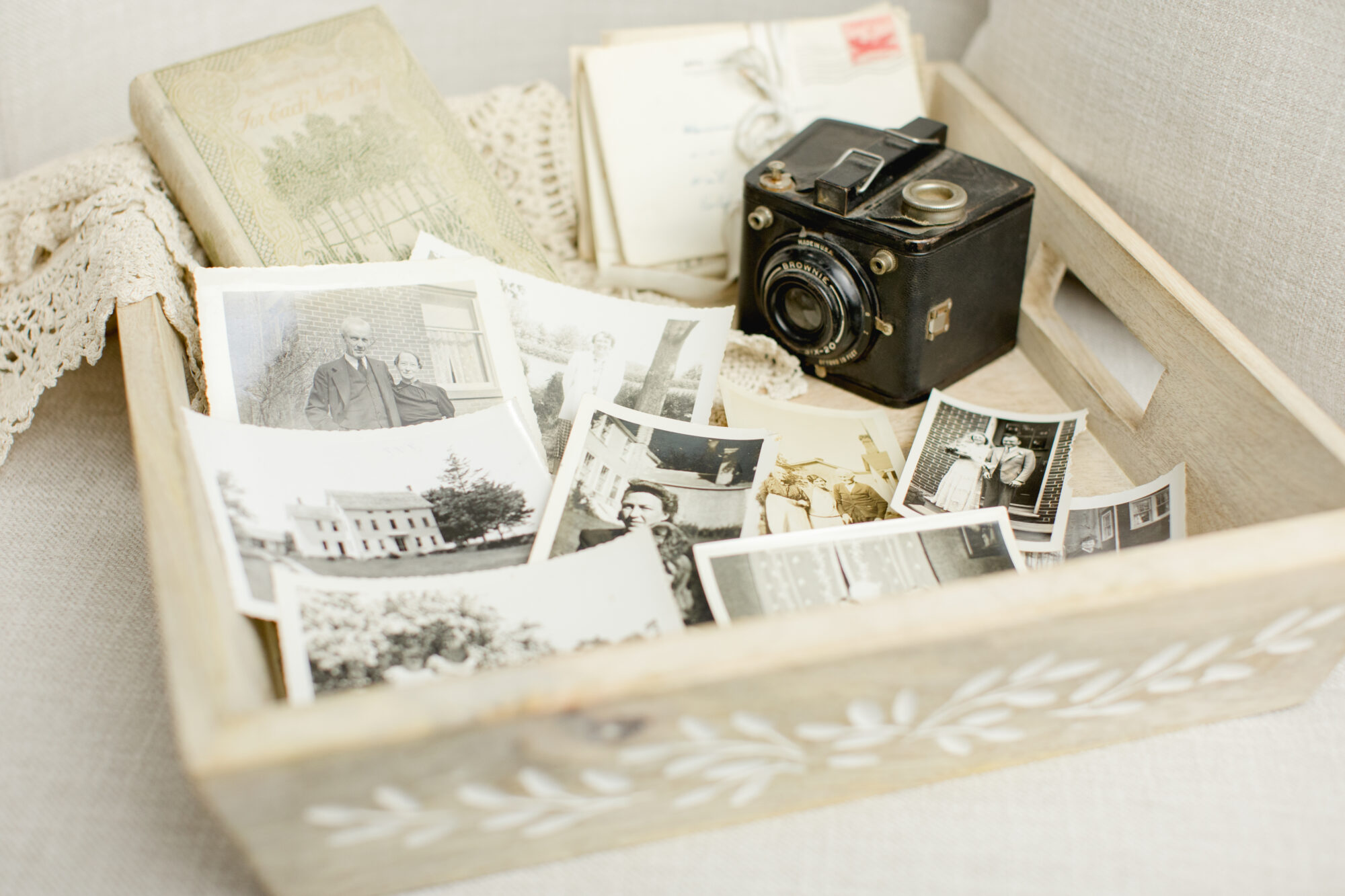 vintage photographs with an old brownie camera in a wooden tray