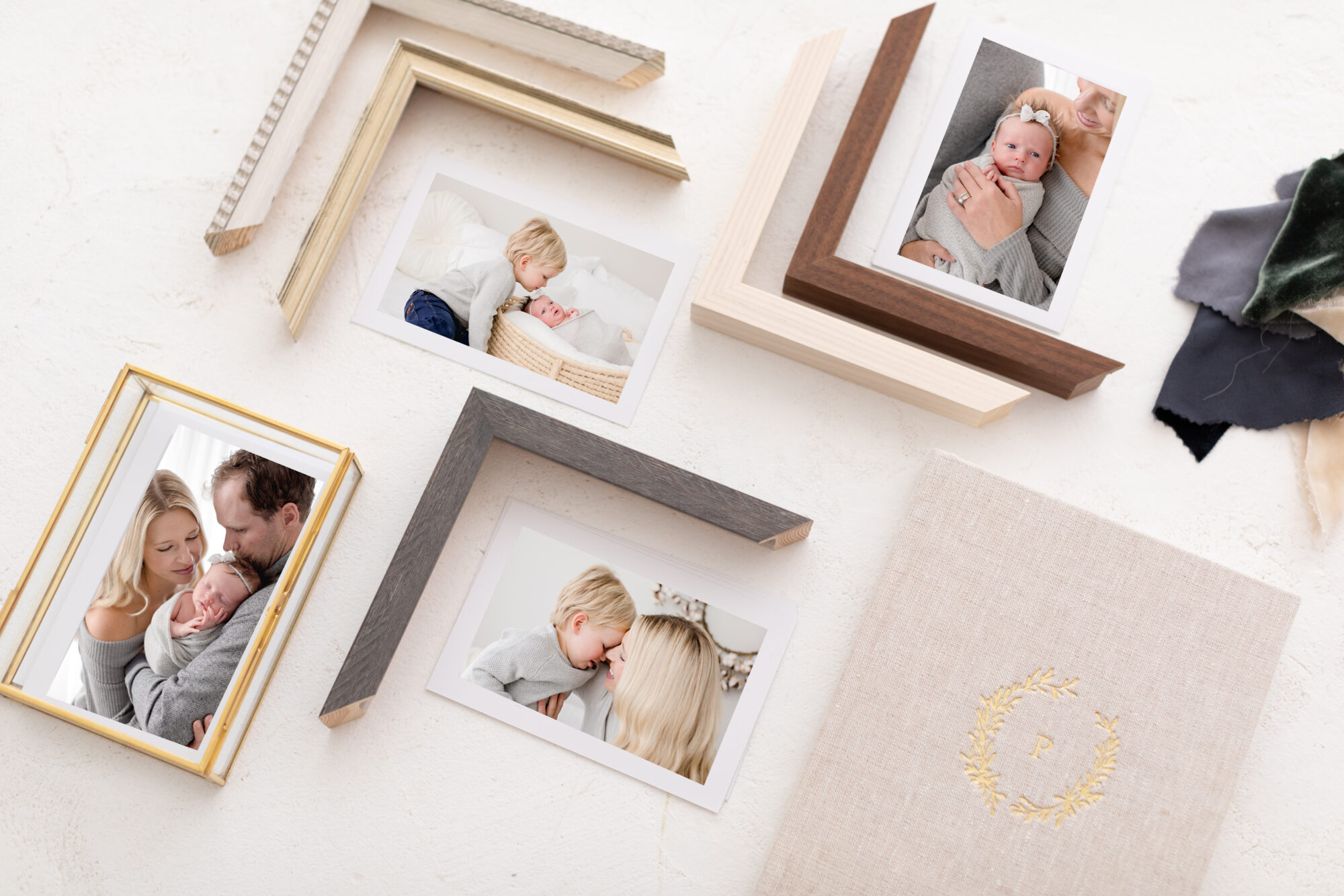 frame samples and printed photographs alongside heirloom albums and cover samples show professional photography products available